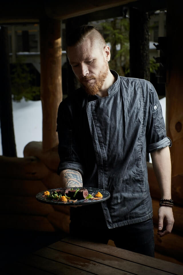 Chief Chef and Owner of Parkash Fitness Paradise Head chef displaying a wholesome mixed salad with leafy greens and natural ingredients