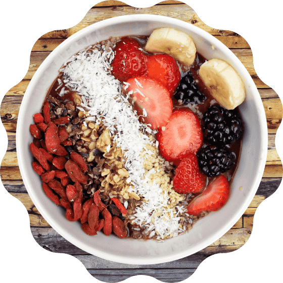 Colorful fruit bowl with banana, strawberry, beetroot, berries, mixed nuts, and millets