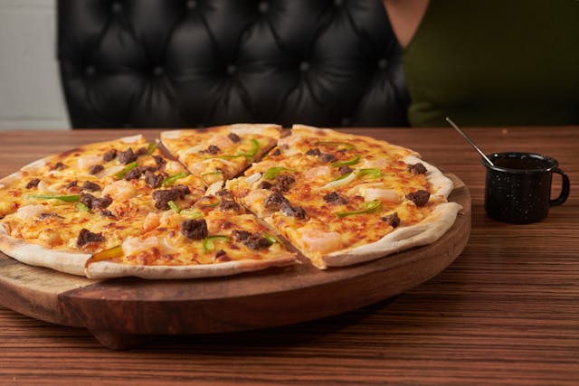 Healthy thin crust pizza on whole wheat base with colorful vegetables